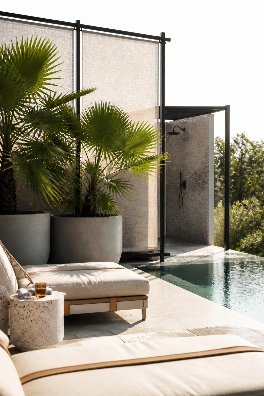 20 Functional Pool Patio Privacy Ideas That Screen Views Without Blocking Light Outdoor pool patio with a black-framed fabric screen, large potted palm plants, lounge seating, and an open shower area beside the water.