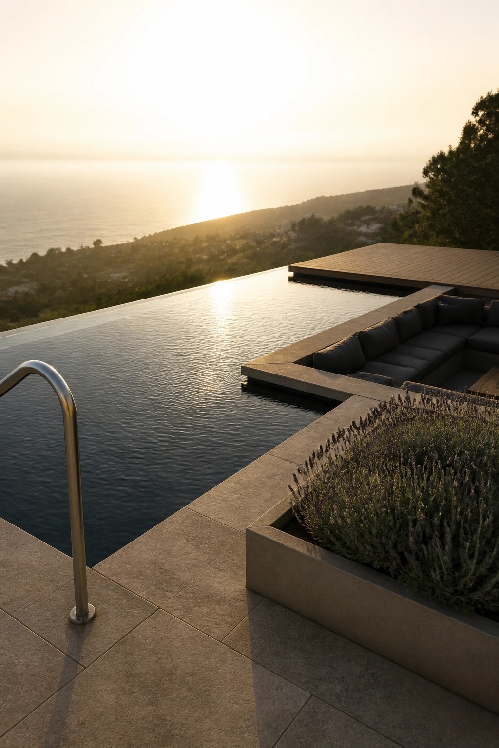 21 Chic Modern Swimming Pool Ideas for a Sleek Outdoor Vibe An infinity pool with built-in concrete sectional seating and a lavender planter overlooking the ocean at sunset.