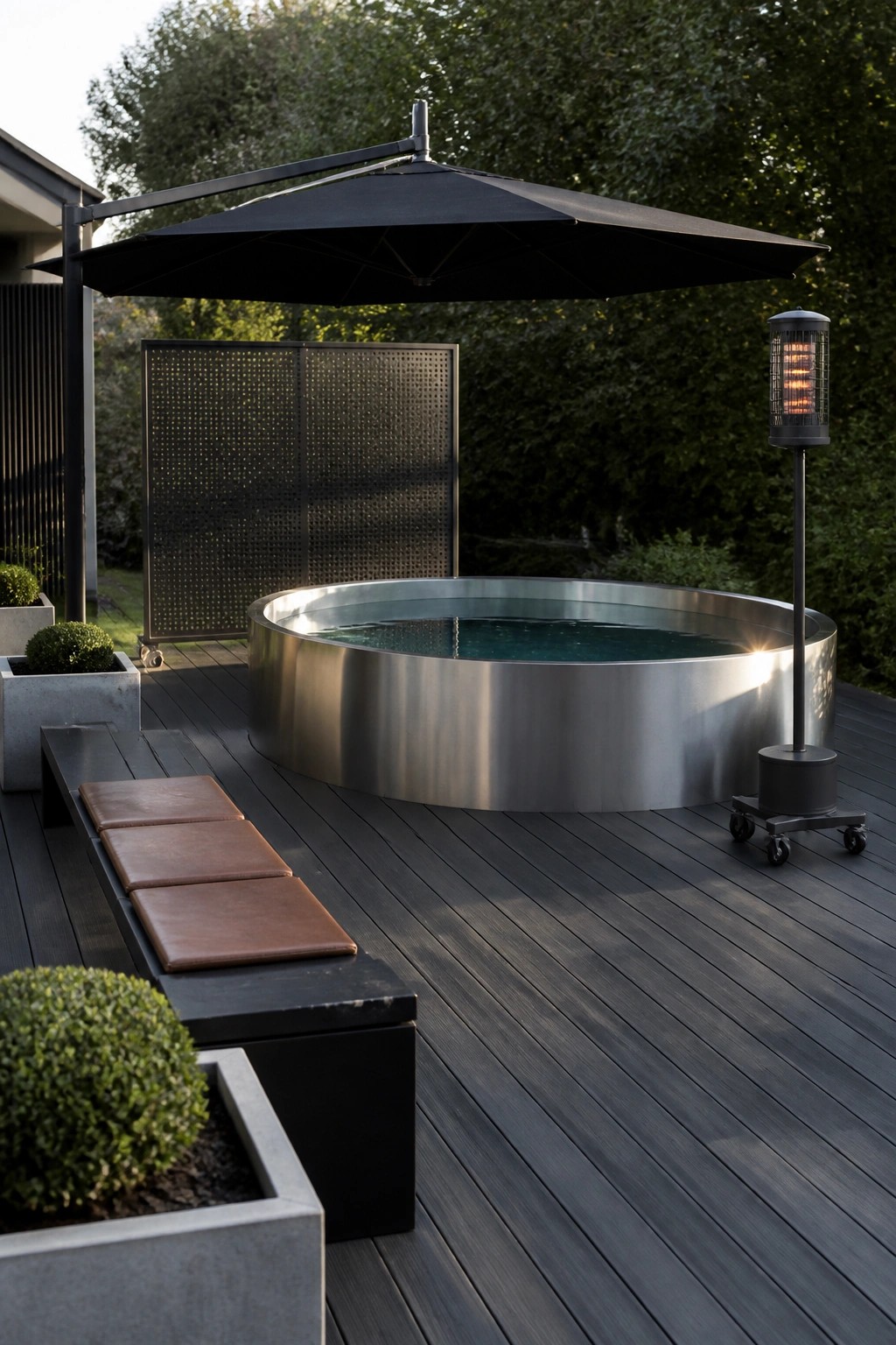 24 Stylish Above Ground Pool Shade Ideas Without Permanent Construction A round stainless steel above-ground pool on a dark wood deck is shaded by a large black cantilever umbrella, with a bench seat and outdoor heater nearby.