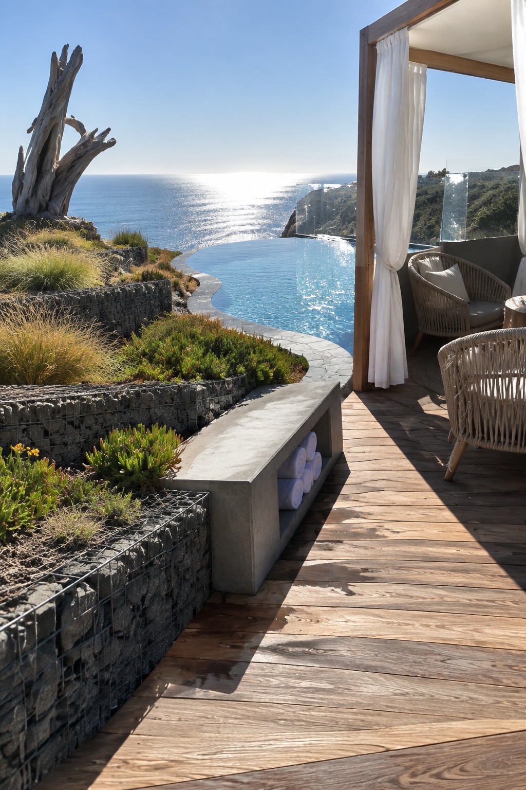 Infinity pool on sunny wooden deck overlooking ocean with wicker chairs